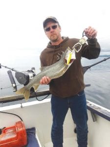 Above: Matt Moss of Lady Smith, Wisconsin, hooked this hefty lake trout using a Beaver Flick purchased at the Beaver House. Moss was fishing with Captain Kelly Shepard of North Shore Outdoors Lake Superior Charters. Fishing on the big lake has been good this season.