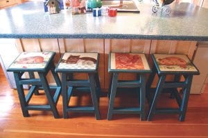 In the bottom level of the Retreat by the Creek birch trees bring in nature to the kids’ room (left) and colorful stools (above) with animals on them brighten this gourmet kitchen.