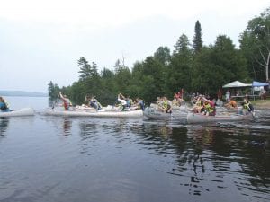 Top: The action was wet and wild as the canoe racers took off during the Gunflint Trail Canoe Races held on Wednesday, July 19 at Gunflint Lodge. Left: As always there was a good turnout of folks who watched and cheered on the race participants. Above: Food, dished by volunteers, is always a big attraction at the races.