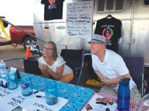 Above: Volunteers answer questions and take in donations at the music festival. Most of the musicians volunteered their time and efforts over the weekend. Right: Todd Miller, board chair of the Grand Marais Music Collaborative, was working hard to sell raffle tickets. At the conclusion of the weekend Miller said, “We couldn’t have hoped for anything better.”