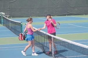 Left: Wearing a cap, Women’s Open Singles Champion Elizabeth Larson (Eden Prairie, Minn.), shakes the hand of runner-up Anna Braun (Carver, Minn.). Above: Double action was fast and furious in the open women’s doubles action taking place at the Cook County Tennis Association’s Fisherman’s Picnic Tennis Tournament. Although there were just 32 tennis players taking part, the courts were full and the tennis played was top-notch.