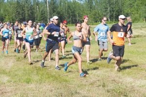 Above: The Fisherman’s Picnic trail run is always an adventure. It features lots of hills and some beautiful scenery on Pincushion Mountain. Louise Ramberg, a CCHS freshman, is shown here running with the lead pack as the race begins. Far left: Wearing bib number 27, Will Loew-Blosser of Bloomington just edged out Grand Marais’ Braidy Powers in the 5-mile walk. Left: The kids’ mile race is always fun. Kids start out running pell-mell before settling down into a comfortable stride or a more comfortable jog-walk.