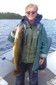 Former Grand Marais resident Andy Brostrom (below) caught this 31-inch walleye on Sunday, July 30. Andy was fishing with his family on a yearly fishing trip they take on the same weekend every year. His mother, Gail Englund (left), caught a 29-inch walleye, which is big, but Andy won the Gold Hook Award for his catch.