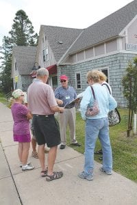 Wearing the movie star sunglasses and working man’s cap is Skip Lamb. Lamb was guiding a group of people on a walking tour of Schroeder for John Schroeder Day. If you missed it, don’t worry; Skip will be leading the walking tour once again this year.