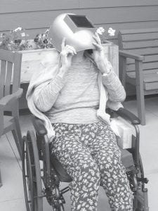 Several residents gathered on the patio on Aug. 21st hoping to catch a glimpse of the eclipse. Pictured here is Marcy Podas taking a look.