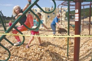 Ruby Hawsen plays on the jungle gym while Natalia Smith and Kelly Hawsen (Ruby’s mom) rake out the chips for the Sawtooth Elementary refurbished playground. Principal Adam Nelson and Principal Bill DeWitt worked alongside a team of volunteers to move and evenly distribute 4-5 semi loads of wood chips donated by Hedstrom Lumber last Friday, August 25. The playground is now bigger than it was before and quite a few pieces of new equipment have been added to it, making it a great place for kids to get some exercise and have a lot of fun.