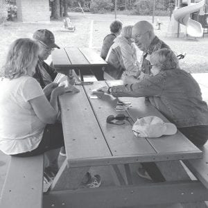 Card playing before the picnic lunch at Grandview Park. Darrellyn Barrett, Fred Schmidt, Geri Jensen, Linda Johnson, Tom Hedstrom, and Kaye Kaft.