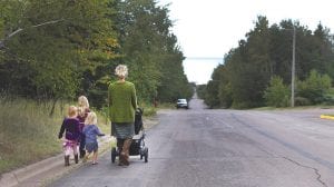 On a nice day, nothing beats walking to school. Here a young mother pushes a stroller and escorts children safely to school. Safe Routes will sponsor the first Walk to School Day on September 20, with three routes of Walking School Buses in Grand Marais.