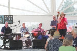 Top: Performing for the Sunday Gospel Hour at the 10th annual Radio Waves Music Festival was Gordon Thorne (guitar) and friends. From L-R: Chris Gillis on piano, Tom Spence on drums, Thorne, Mike Roth on bass and Carah Thomas singing lead vocals. Left: Joe Paulik belts out a tune with Pat Flack on bass. Above: The kids' activity tent was a busy place during the three-day festival that drew over 1,300 people. WTIP Development Director Jana Berka thanked the many volunteers, musicians and people who attended. “It was an awesome weekend and we intend to do it again next year,” she said.