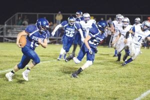 Top: With Mikey Burton out front blocking, Andrew Miller turned the corner and headed downfield on a long run in the Vikings big win over Silver Bay. Left: Wearing No. 14, Viking running back Ethan Sporn left this Mariner tackler in the dust as he ran for some of his more than 200 yards on the day. Above: Big Billy Hackett (72) cleared the way for the Viking runners all day and was named Offensive Player of the Game.