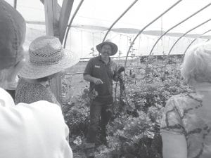 The administrator for the Wolf Ridge Farm, David Abazs, displays a blood beet to the Grand Marais Garden Club members who toured the facility recently. The garden club also toured Finland’s Organic Consumers Association farm as part of their trip.