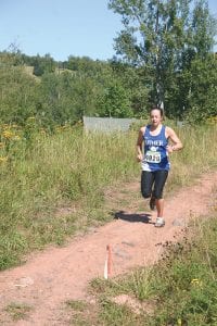 Showing some fatigue, Emma Spoon was nearly at the finish of the very tough, grueling Moose Mountain Marathon when this picture was taken. Despite a hard fall, Emma won the women’s race and set a new course record.