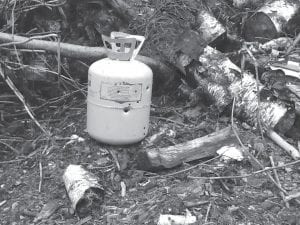 Some inconsiderate “sportsman” left this metal refrigerant canister in the Pike Lake brush pile after a target shooting session. Should you recognize its owner call the Sheriff’s Department or the U.S. Forest Service enforcement officer.