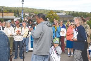 Delwyn Wilson, with 2017 Grand Portage Tiny Tot Princess Nevaeh Deschampe holding onto him, read a piece created by Nevaeh asking people to be like leaves. Leaves of all colors appear on the same tree in the fall and live in harmony. Why, then, can’t people of all colors live together like leaves in peace and harmony? Out of the mouths of babes, as they say.