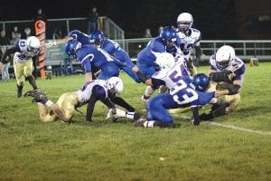 Above: Mikey Burton (33) throws a nice block on this play as Ethan Sporn runs the ball. Burton also caught a nice 22-yard throw from Josh Prom for a touchdown. Left: Dillon Sjogren (44) and Ethan Sporn (14) get set to throw a “block party” for Josh Prom (9), who is carrying the ball. Far left: Sophmore Jordan Porter picked up 18 yards on this reception on a throw from sophomore quarterback Adam Dorr.