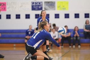 Above: On bended knee, Raina Ryden made a great play on this ball to set up her front line as Alyssa Fenstad Lashinski watches in the background. Right: At a smidgeon over five feet tall, Sophie Eliasen was a good foot above the net as she went up and slammed the ball back to the Mariners.