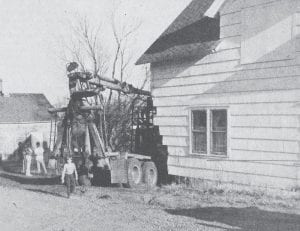 A driverless runaway logging truck inflicted considerable damage to the home of Alvin O. Anderson on the corner of Fourth Street and First Avenue East in May 1976. The truck crashed into the rear corner of the residence, causing an undetermined amount of damage to the north and east walls. A spokesman for the company that owns the truck said it was parked on the west side of First Avenue East when it was evidently tampered with by vandals who released the brakes. Damage to the truck was estimated at over $7,000. The family was not home at the time of the accident.