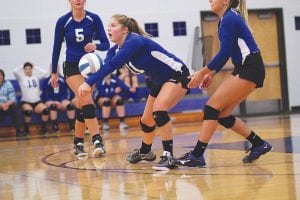 Raina Ryden bumps the ball to her front line in a match against the Carlton Bulldogs. Head volleyball coach Pam Taylor asked Raina to come forward between games to receive a commemorative volleyball for recording her 1,000 set assists as a varsity player for the Vikings. Great job, Raina!