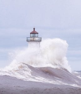 November is the best time to take storm pictures of Lake Superior. Here the lighthouse in the Grand Marais harbor is nearly encapsulated by a giant November wave.