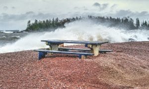 This picnic table wasn’t the only thing that was buried or damaged by the wave driven water of Lake Superior in the county’s first winter storm of the year. Late Thursday, October 26, snow started to fall. It was preceded by rain and winds that gusted up to 50 miles per hour. Beach sand, twigs and sticks washed onto the streets of downtown Grand Marais, and trees blew down throughout the area.