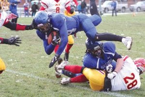 Left: If you can’t go by land, then go by air. Ethan Sporn dove over Dillon Sjogren, who had flattened the would-be MIB tackler (28) to gain a few more yards on the play. Above: Connor Somnis (wearing the fanny pack) and Devon Premo (22) wrap up the MIB ball carrier. Top: Jack Haussner made a great play to intercept this ball at the Vikings’ goal line with 16 seconds left in the game against MIB.