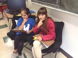 Above: School newspaper editors MaTaya Fairbanks and Molly Quello. Left: Ayden DeRosier makes observations in the garden.