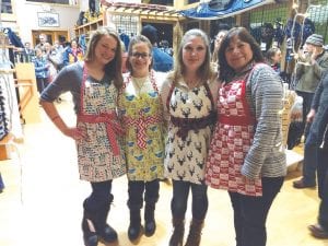 Stone Harbor Wilderness Supply hosted a fashion show for the Storm Fest. Taking part were staff from Joynes Ben Franklin, Gunflint Mercantile, and Stone Harbor. Above, all wearing handcrafted holiday aprons created and sewn by Chelsea Lueck, owner of Gunflint Mercantile, are her four “apron models” from L-R: Britt Edlund, Kelly Phelps, Brittany Lilienthal, and Jean Mathis Spry.