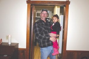 Steve Prince holds his two-year-old daughter Maya in the doorway of the kitchen to the Wunderbar. Prince, who is a producer and writer from Texas, was in town recently looking for stories about local ghosts and possible locations to film an upcoming movie.