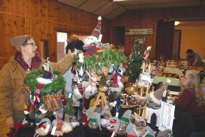 The holidays are in full swing with local crafts and talents on display all around Cook County. Dusty Nelms (right) peruses the handmade gifts, crafts, paintings and pictures featured at the Hovland holiday craft sale two weekends ago.