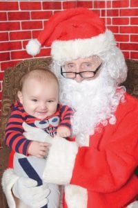 Santa paid a visit to the Girl Scouts Santa’s Workshop on Saturday, December 2 at the First Congregational Church in Grand Marais and look who ended up in his lap? This smiley little fellow was tickled pink to meet the jolly old St. Nick! Mr. Letson didn’t have a list with him for Santa because he’s too little to write, but it looks like his most significant gift was his chance to meet the legendary gift giver.