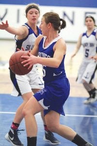 Getting ready to throw a nice bounce pass in the game against Silver Bay was Viking senior guard Maya McHugh.