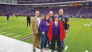 Helping to make Jennifer Rue’s dream come true to attend a Vikings football game were L-R: Brad Madson, Vikings Executive Director Community Relations/Youth Football, Liz Dawson, Cook County Administrator Jeff Cadwell, Jennifer Rue, and Bruce Messelt, Chisago County Administrator/Association of Minnesota County Administrators.