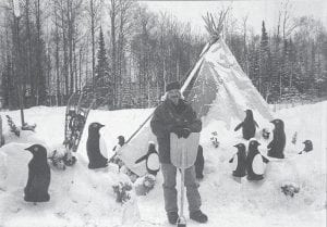 The 18th running of the John Beargrease Sled Dog Race was a festive occasion in January 1998. Winners were Jamie Nelson of Togo, Marathon; Dan Bergerson of Grand Rapids, Beargrease 190; and Bruce Kohlhase of Minneapolis, Beargrease 100. As usual the race course featured several checkpoints along the way, including this one staffed by Bill Berry and his flock of penguins, who staffed the teepee at the Devil Track checkpoint.