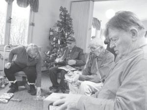 Seniors gathered at the Cook County Senior Center for a friendly game of Farkle. To win at Farkle you must take turns rolling dice. On your turn, you roll all six dice. A one or a five, three of a kind, three pairs, or a six-dice straight earn points. First to 10,000 wins.