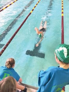 Left: At the most recent swim meet held in Duluth, Ella Hedstrom shows off great form in swimming the 500-freestyle. Top: Haddon Taylor powers to a first place in his 50-yard heat. Above: Performing the hardest, most grueling stroke, Shaelyn Hingos competed in her first 100-yard butterfly competition.