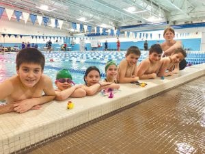 In between races the local kids competing for the Northerns YMCA swim team take a break. From L-R: Haddon Taylor, Kajsa Ekstrom, Aurora Gallagher, Martine Redshaw, Isaak Lien, Finnley Taylor, Silas Ekstrom and Jack Willis.