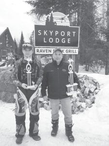 Below right: Corry Napper (left) and unknown racer with their trophies.