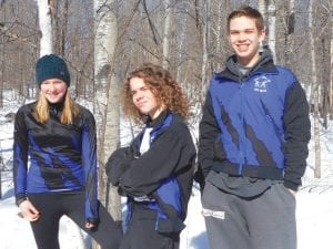 Above: Three up and coming Cook County High School Nordic skiers are, from left, Malin Anderson, Danny Berka and Trent Spry. Left: Poling hard to the finish is Claire LaVigne.