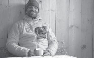 Before heading up another cold mountain Grand Marais cold weather adventurer Lonnie Dupre enjoys a hot cup of coffee.