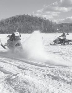 Left: Devyn Deschampe (50) sends a “rooster tail” of snow flying as he takes off in the Ridge Riders’ snowmobile drag races held on Saturday, Feb. 17 at Hungry Jack Lake. Below: Event winners proudly display their trophies for recording their fast times. The Ridge Riders next big event is the Fish Derby that will be held Sunday, March 4 at Gunflint Lake from 9 a.m. to 2 p.m.