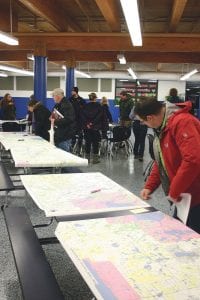 The DNR hosted a listening session for the proposed Borderto Border off-road trail that will run from North Dakota to Cook County and about 30 people came to listen, ask questions, and give input. Here Gunflint Ranger Michael Crotteau examines one of the many maps that display the current proposed route.