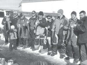 Turnout for the 2018 Ridge Riders’ annual trout derby held on Gunflint Lake, Sunday, March 4 was good, with over 100 people in attendance on a windy but sunny day with temperatures in the low 30s. All told 17 lake trout were entered in the contest with the biggest, a 5 pound, 7 ounce lunker caught by Cameron Hood, taking the first prize of an ION ice auger. Proceeds from the trout derby are used by the club to maintain the trail system and trail grooming equipment. Above: Contest winners, from left, are Doug Finn, Kyle Anderson (House), Jack Radloff, Thomas Anderson, Darin Fagerman, Casey Pederson, Jacob Schroeder, Cameron Hood, Jason Benck. Left: Stephanie Radloff takes a long look at the fish entered in the contest.