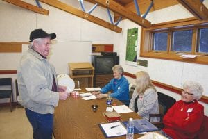 A smiling Art Anderson gets set to vote in the Schroeder election. The election judges, from left, are Carol Tveekrem, Lavonne Anderson, and Jan Dillon. Art, who is married to Lavonne, was getting some teasing from the judges about wearing bright white new tennis shoes.