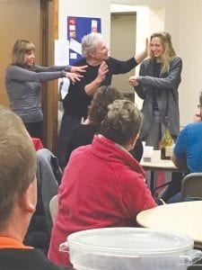 Left: There was magic in the air at the Charles J. Futterer Memorial Bonspiel this past weekend. No, not pretend magic, but real magic. At left Cindy Posmituk and Anna Futterer assist magician Chaz Misenheimer with one of his many tricks. When Chaz wasn’t entertaining the crowd he was curling. Above: Getting a hug from Joanne Smith, Bob Hedstrom accepts the runner-up check. Hedstrom, a CCHS graduate, now lives in St. Paul where he skips a curling team.