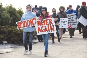 Marchers in Cook County symbolically joined with marchers throughout the country on Saturday, March 24 in an effort to send a message to Washington to change gun laws to make the streets and schools of the nation safer. Leading the march was Sammie Garrity who was holding the sign “Never Again” and Grace Ritchey, whose sign was soon corrected and read “Enough”.