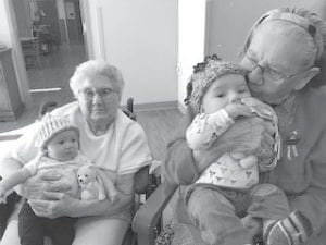 Above: Bernice Legarde and Gloria Martineau enjoyed some “cuddle time” with some very special little guests at the “Babes N’Bonnets” Social held on March 10. Left: Karin Goodell, one of our dedicated volunteers, dressed for the occasion to celebrate Dr. Suess’ birthday during her reading group recently.