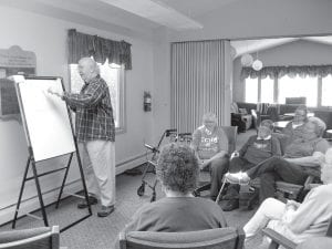 A group of locals gathered at the Cook County Senior Center recently to engage in a game of Pictionary. Above, Tom Hedstrom is at the drawing board while his playing partners from L-R: Linda Johnson, Nona Smith, Bev Green in back, Patsy Smith, Gladys Anderson and Theresa Morrison try to guess what Tom, no Vincent Van Gogh, is attempting to draw.