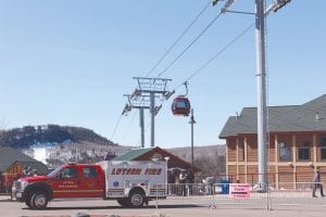 When Lutsen Mountains purchased and installed the cherry-red gondolas a few years ago not only did their winter ski lift business increase, but so did the scenic rides offered, especially in the fall when the leaves turn, to area visitors. While no accidents have occurred in the three years the gondolas have been in operation, there is always the chance a mechanical breakdown could happen and gondola riders could be stranded mid-lift. With that in mind, local rescue workers and Lutsen Mountains staff teamed up with trainers from the Twin Cities to learn how to evacuate people from a gondola using a helicopter if the need ever arises.