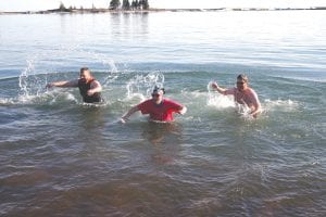 Above: How cold was Lake Superior on this day? Cold enough to have ice chunks floating in the bay. Cold enough to take Peter Lucken (left), Megan Ruebbelke and Kris Hoffman’s breath away! That’s how cold the water was at 6 p.m. on Wednesday, April 18 as I.S.D. 166 school teachers Lucken, Rubbelke and high school counselor Kris Hoffman made a practice run to get ready for the “Nordic Dunk” fundraiser that will be held May 1 at the same Lake Superior Trading Post beach location. Left: Lucken and Rubbelke high five while Hoffman thinks about how happy he is to be alive.