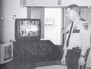 Cook County Sheriff Dave Wirt studies the console of the command center in the new Law Enforcement Center, which opened in 1998.